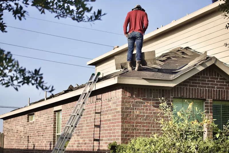 Professional roofer working on a residential roof in Iselin